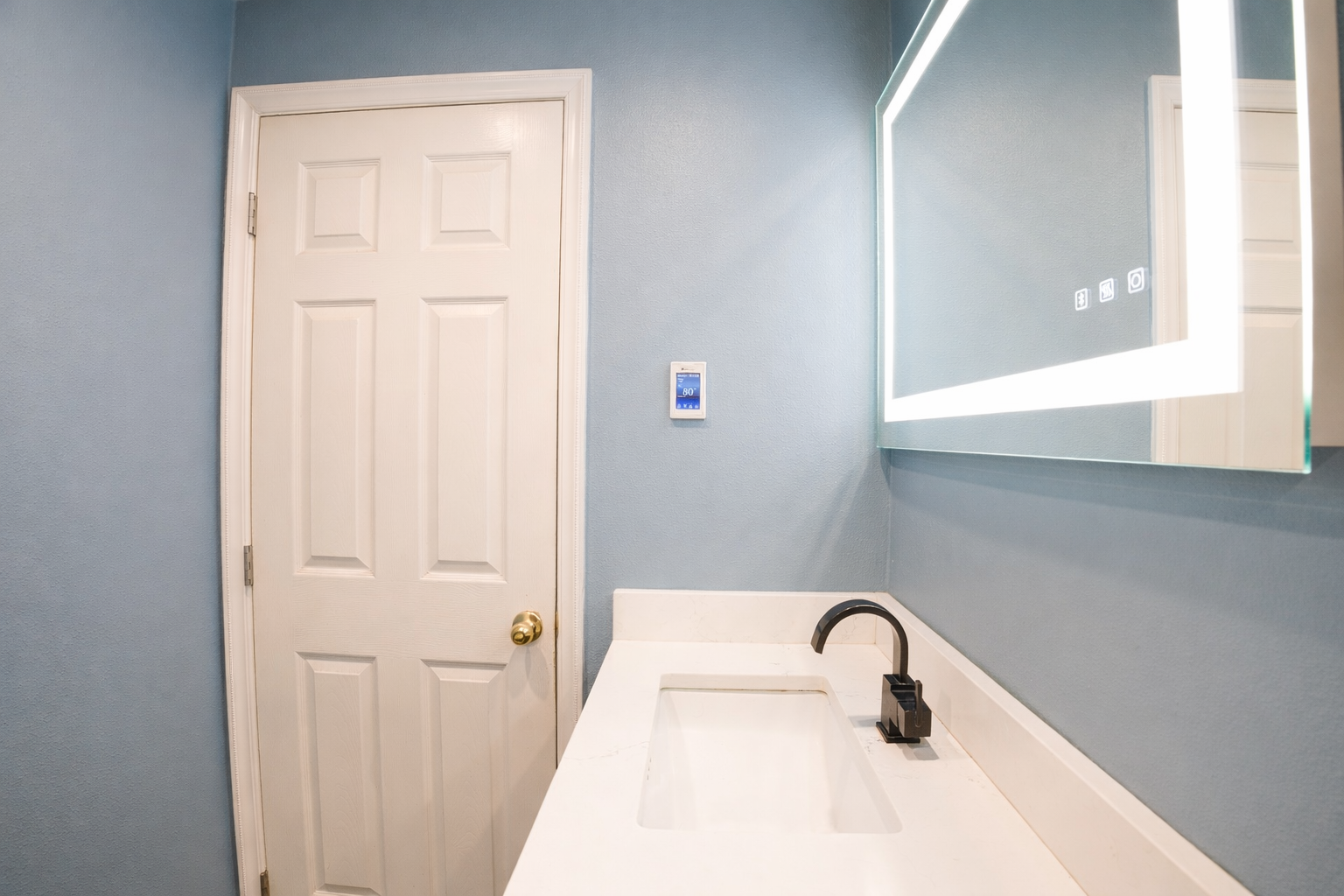 Bathroom vanity with an illuminated mirror