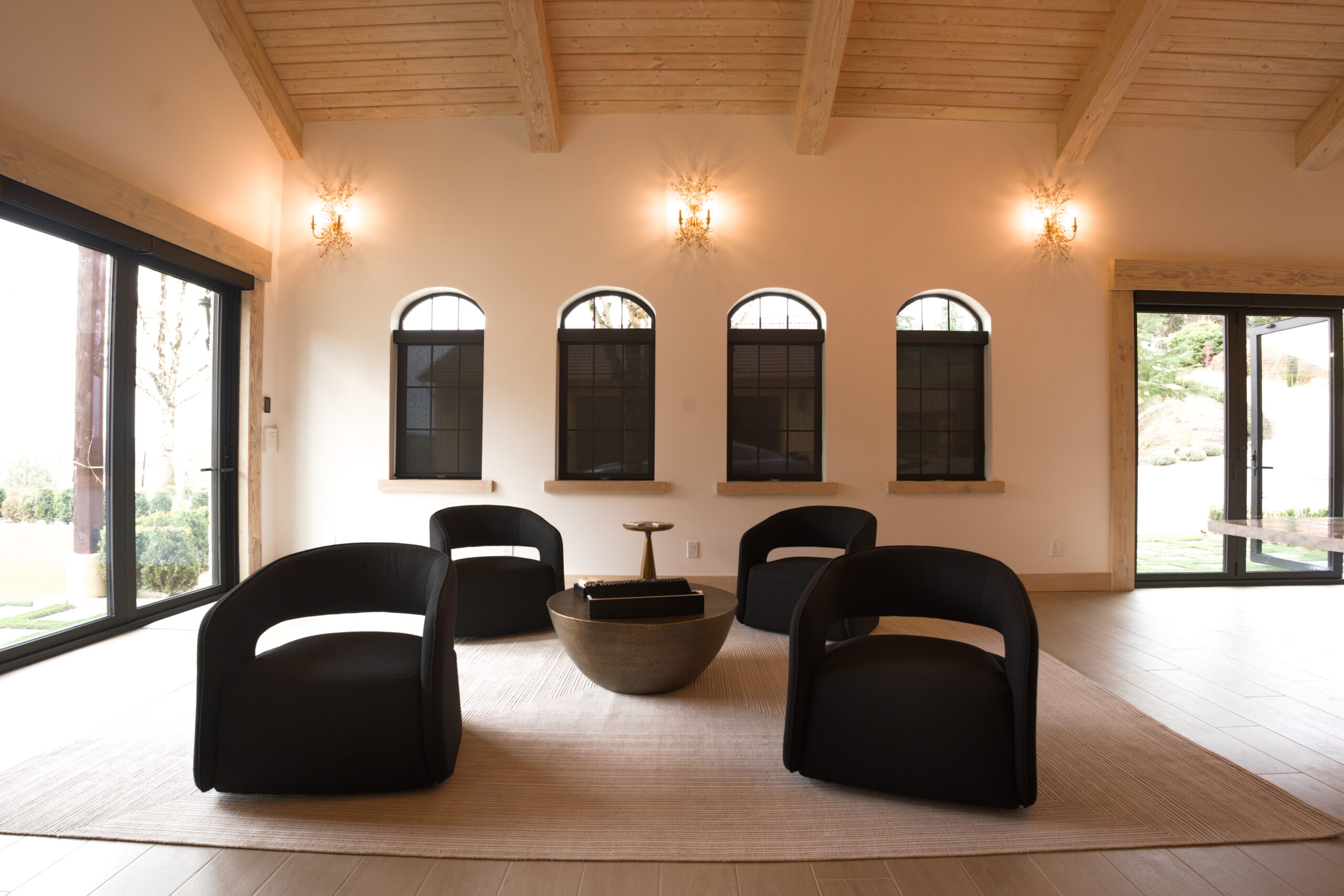 Warm finished interior with arched windows and wood ceiling