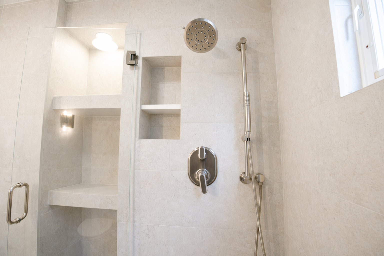 Tiled walk-in shower with recessed niches